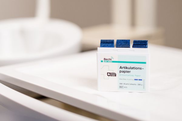 Becht articulating paper displayed in a compact dispenser box on a dental unit.