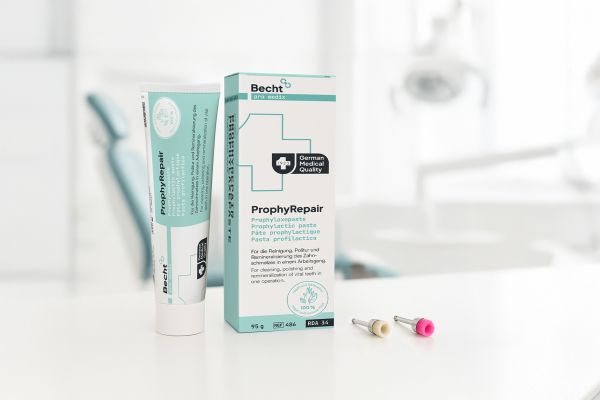 ProphyRepair prophylaxis paste and natural dental floss from Becht on a white table in a modern dental practice setting.