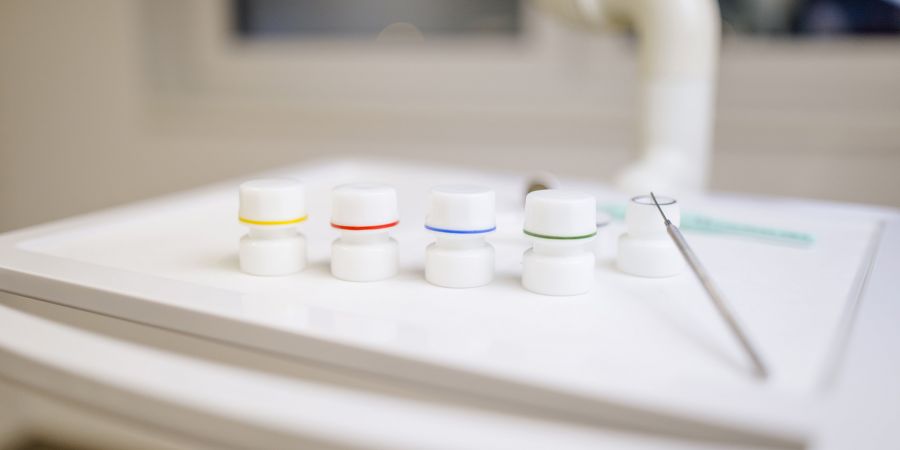 Dental Cap Dishes for Professionals White dental cap dishes with colored rings on a tray in a dental office.