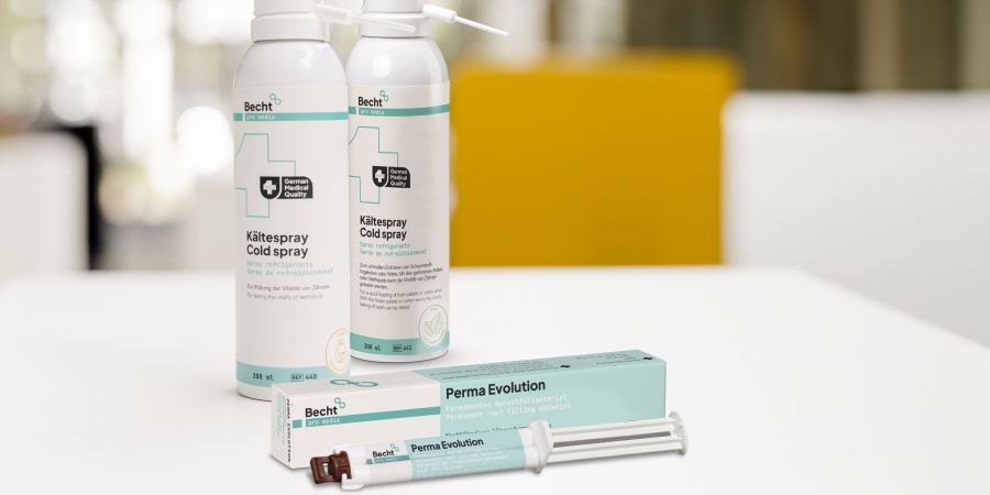 Becht cold spray and Perma Evolution root filling material on a white table in a modern dental office. The products are used for pulp vitality testing and permanent root canal fillings in endodontics.