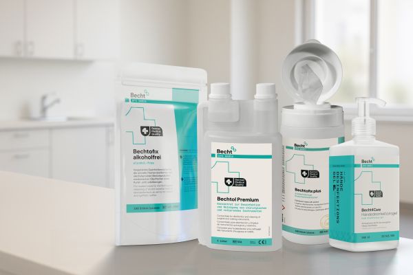 Several Becht disinfectant and hygiene products displayed on a light countertop in a modern clinical setting.