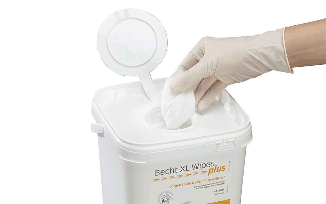 Becht XL Wipes Plus by Alfred Becht, pre-soaked disinfectant wipes in a practical dispenser box, being pulled out with a gloved hand.