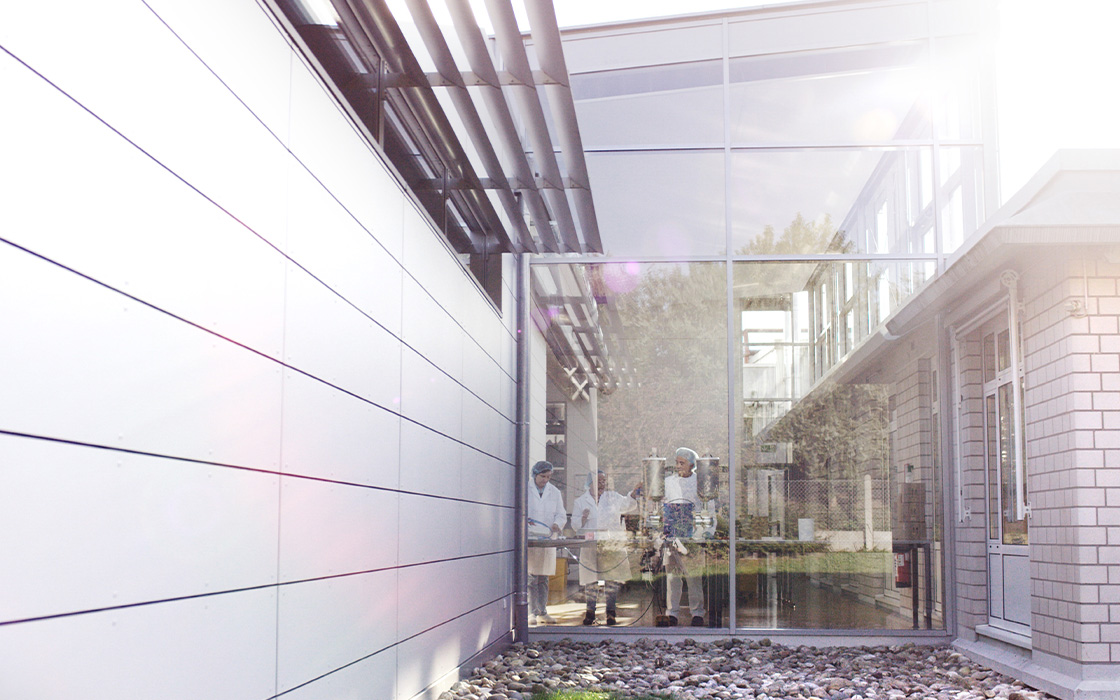 Modern Alfred Becht GmbH facility with glass façade and production areas, for manufacturing and storage of medical products.