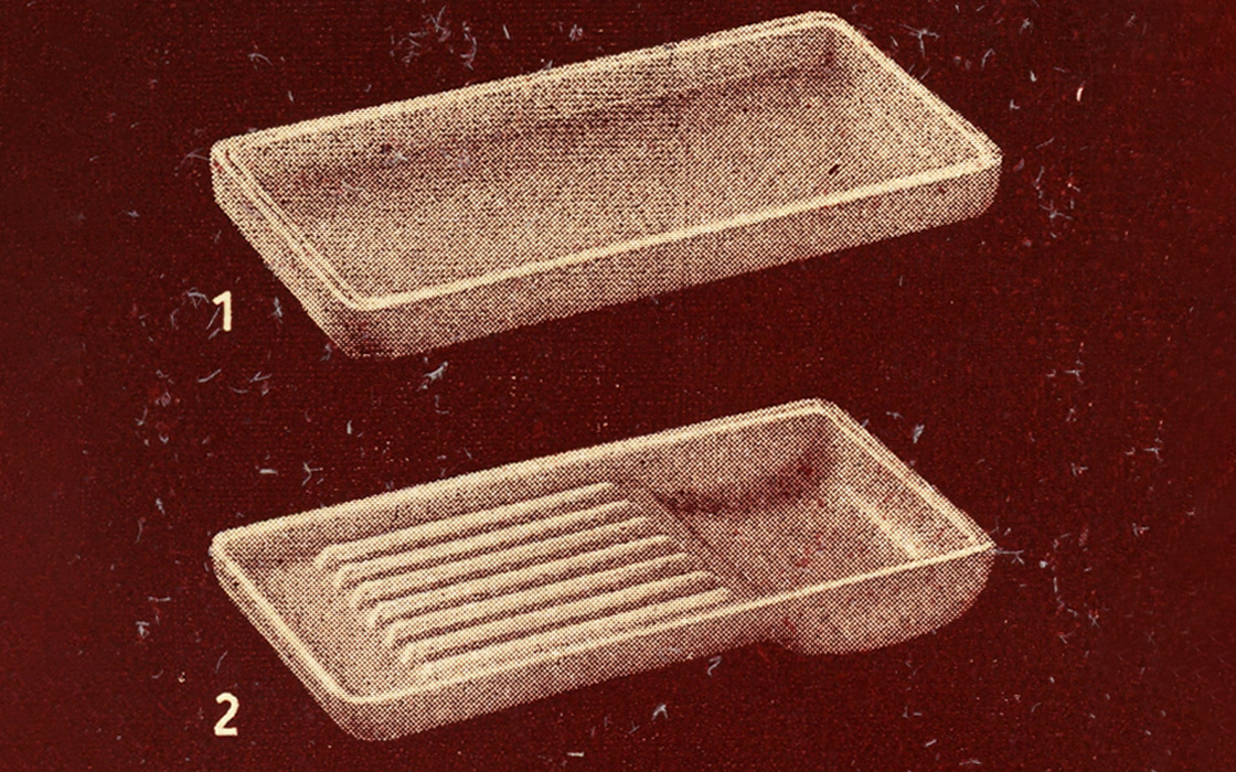 Two rectangular opal glass trays for dental instruments, one smooth and one ribbed, shown against a red background.